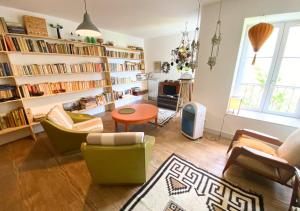 a living room with a lot of bookshelves at Chez Nellane - Poitiers - HyperCentre in Poitiers