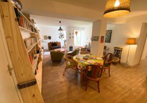 a dining room and living room with a table and chairs at Chez Nellane - Poitiers - HyperCentre in Poitiers