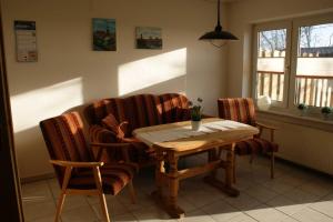 a table and chairs in a living room with a table and chairs at Ferienhaus Dollartbrise 45005 in Pogum