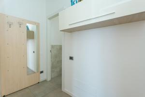 a bathroom with a white wall and a mirror at Station's Apartments Bergamo in Bergamo +141 photos