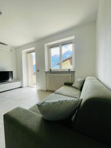 a living room with a couch and a large window at Maison Syrah in Aosta