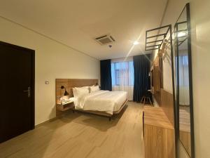 Ένα ή περισσότερα κρεβάτια σε δωμάτιο στο Hotelinn Oniru