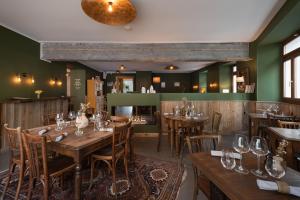 a dining room with wooden tables and chairs at Hôtel Maison Doron in Beaufort