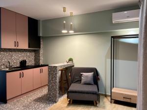a kitchen with a chair and a table and a counter at elenasrooms in Kallithea Halkidikis +21 photos