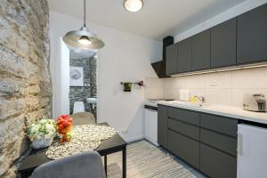 a kitchen with a table and chairs and a counter at Tallinn Old Town Romantic Apartment in Tallinn