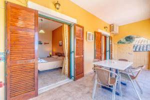 a room with a table and chairs and a bedroom at Two bedrooms apartment Vasillis in Paleokastritsa +19 photos