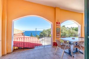 a dining room with a table and chairs on a balcony at Two bedrooms apartment Vasillis in Paleokastritsa
