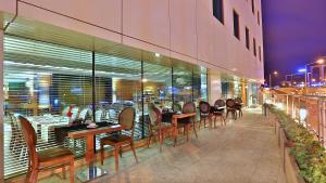 a restaurant with tables and chairs on a balcony at Park Inn by Radisson Istanbul Asia Kavacik in Istanbul