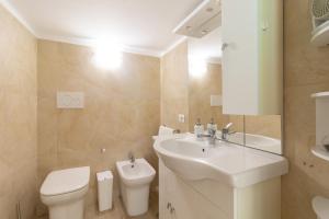 a white bathroom with a sink and a toilet at Zelda Casa Vacanza in Giovinazzo +17 photos