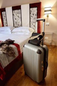 Postel nebo postele na pokoji v ubytování Trianon Borgo Pio Aparthotel