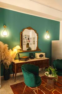 a room with a mirror and a desk with a chair at Hotel TEA - Praia a Mare in Praia a Mare