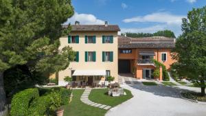 a large house with a garden in front of it at Agriturismo La Filanda in Manerba del Garda