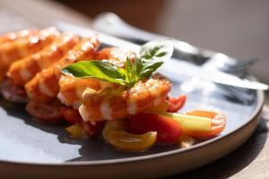 a plate of food with shrimp and vegetables on a table at Hotel Isola Sacra Rome Airport in Fiumicino