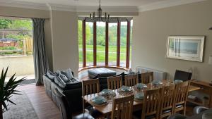 a living room with a table and a couch at The Farmhouse at Solsgirth Home Farm in Dollar