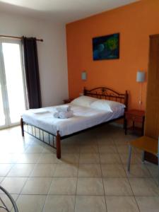 a bedroom with a bed with towels on it at Emmanouil in Kythira