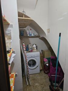 a laundry room with a washing machine and a washer at Villa Del Sol in S'Agaro