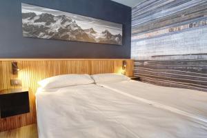 Posteľ alebo postele v izbe v ubytovaní Sui Generis - Aosta Urban Apartments