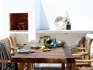 a wooden table with food on it in a dining room at The Cottage Collection Paternoster in Paternoster