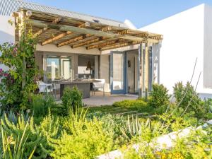 a pergola in the garden of a house at The Cottage Collection Paternoster in Paternoster