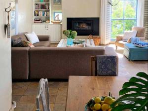 a living room with a couch and a table at The Cottage Collection Paternoster in Paternoster
