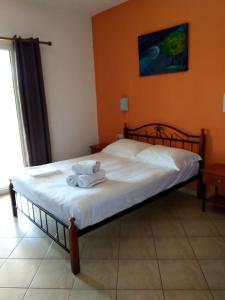 a bedroom with a bed with a teddy bear on it at Emmanouil in Kythira