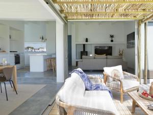 a living room with a couch and a table at The Cottage Collection Paternoster in Paternoster