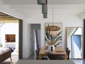 a dining room with a table and a couch at The Cottage Collection Paternoster in Paternoster