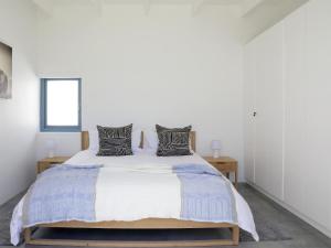 a bedroom with a large bed with two pillows at The Cottage Collection Paternoster in Paternoster