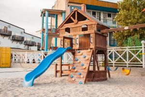 a playground with a slide in the sand at VIP Hotel in Koblevo