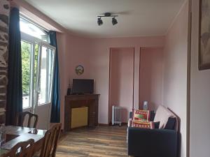 a living room with a table and a dining room at Appartements touristique - La Colombière in Lourdes
