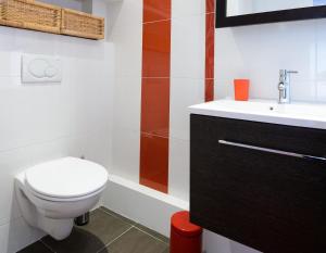 a bathroom with a toilet and a sink at La Campagne à Paris B&B in Paris