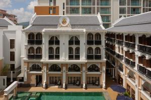an aerial view of a building with a swimming pool at CHINO@NIMMAN Luxury Boutique Hotel in Chiang Mai