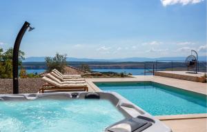 a swimming pool with a view of the water at Beautiful Home In Jadranovo in Jadranovo