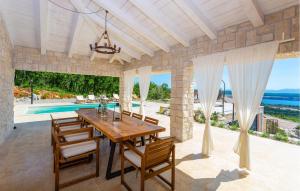 a dining room with a table and chairs and a pool at Beautiful Home In Jadranovo in Jadranovo +36 photos