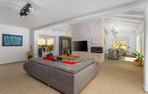 a living room with a couch and a brick wall at Beautiful Home In Jadranovo in Jadranovo