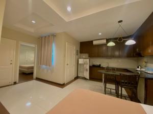a large kitchen with a table and a counter top at Prism Hotel in Angeles