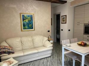 a living room with a white couch and a table at Casa Argegno in Argegno