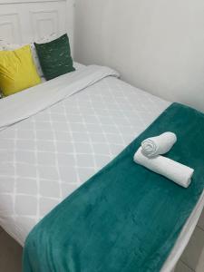 a bed with two towels sitting on top of it at Bella Homes Thika Town in Thika