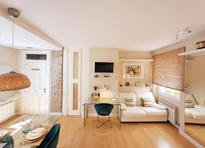 A television and/or entertainment centre at ApartaSuite Centro Histórico Ático tranquilo y luminoso en el corazón de Granada