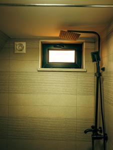 a window in a bathroom with a camera at Gold cottages Kazbegi in Kazbegi +29 photos
