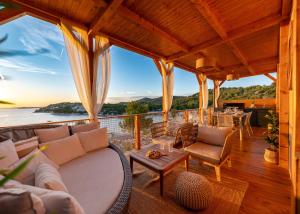 een veranda met banken en uitzicht op het water bij Venettus premium mobile home in Drage