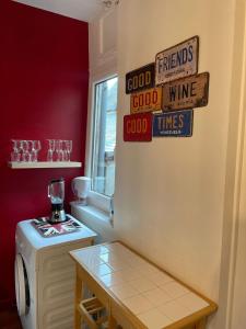 a kitchen with a refrigerator with signs on it at Auron - 4 personnes - Hypercentre in Bourges