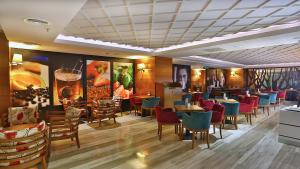 a restaurant with colorful chairs and tables in a room at Park Inn by Radisson Istanbul Asia Kavacik in Istanbul