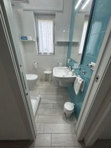 a bathroom with a sink and a toilet and a tub at Casa vacanze SoleeMare Barletta Apartments in Barletta