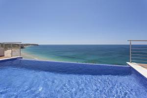a swimming pool with a view of the ocean at Villa Mar à Vista by VILA VITA Collection in Salema