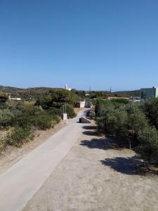 a dirt road with trees and bushes on it at Emmanouil in Kythira