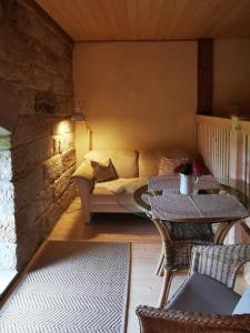 a living room with a couch and two tables at Ferienwohnung Galerie in Bad Schandau