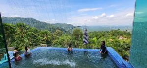 a group of children playing in a swimming pool at SANKARA GARDEN in Pantai