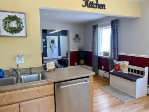 a kitchen with a sink and a counter top at Cozy Main Street Flat in Adrian