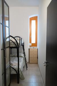 a bedroom with a bunk bed and a window at Tra le vie del mare, Quality Apartment in Conversano